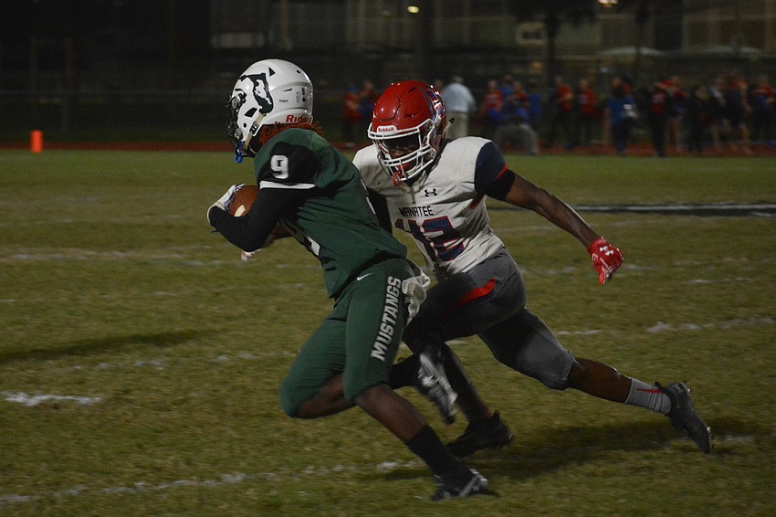 Lakewood Ranch wideout Jaleel Duncan tries to get past a Manatee defender.