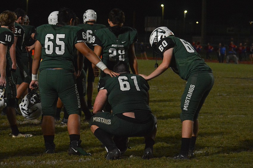Lakewood Ranch senior guard Ayden Delk (61) is comforted by teammates including Anthony Cummings (28) after the game.