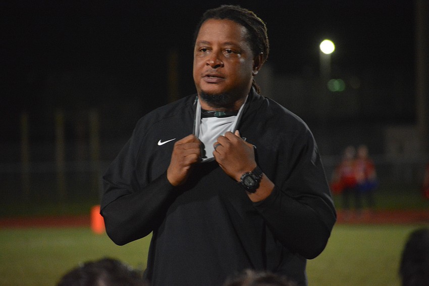 Rashad West talks to his team following the loss.