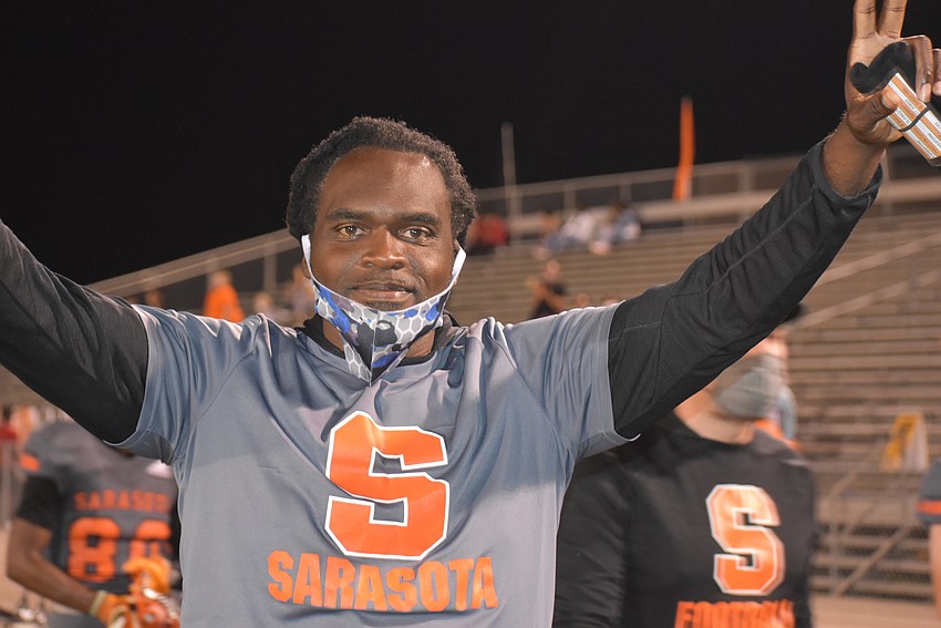 Sarasota linebackers coach Tyrell Burton celebrates a Dom Bennett kick return touchdown that brought the Sailors within 14-7 of Lehigh late in the first half.