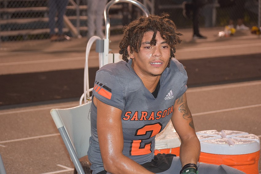 Sarasota senior Dom Bennett takes a breather after racing for a long kick return touchdown that cut Lehigh's lead to 14-7 late in the first half.
