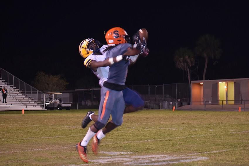 Sarasota senior Terrell Pack out-jumps Lehigh senior Omarion Cooper for a reception in the dying seconds of the first half. Pack would reel in a 40-yard touchdown on the very next play, the last before halftime.