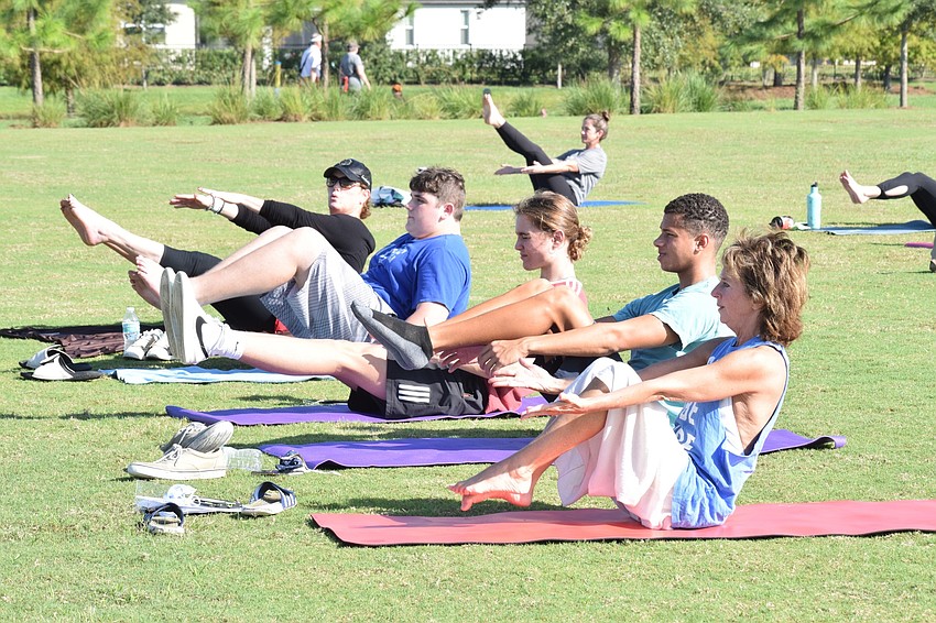 Participants relax while doing yoga together.