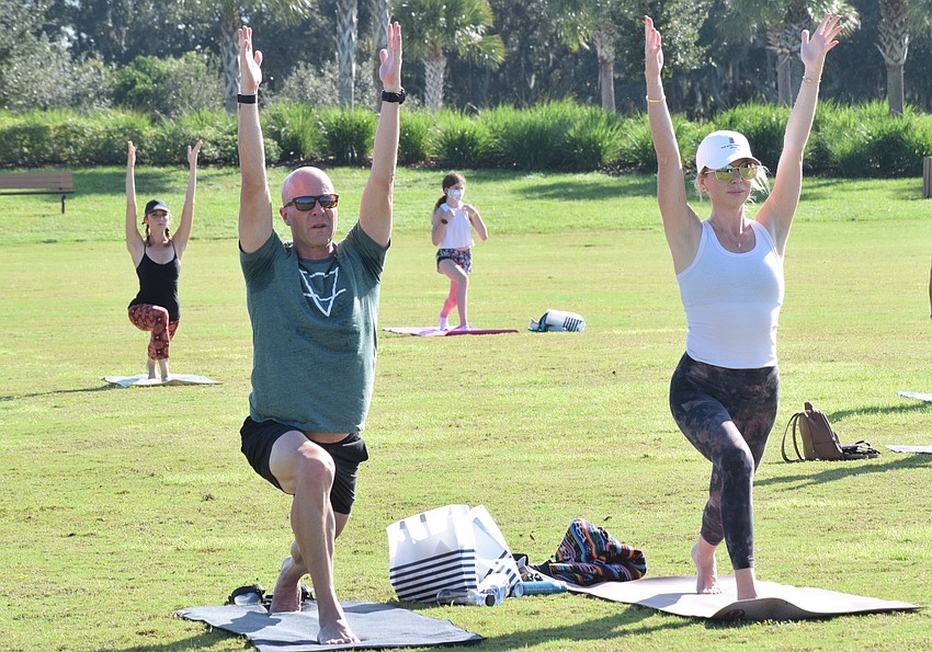 Lakewood Ranch's Daniel Kirschner and University Park's Sarah Macrae follow along during the yoga portion of the Mindful Triathlon.