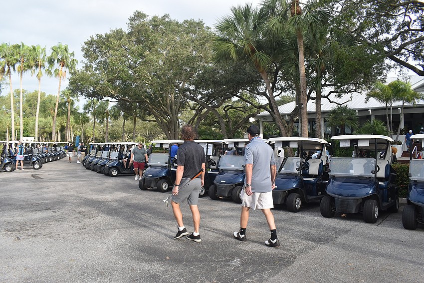 A small fleet of golf carts waits to head to the courses.
