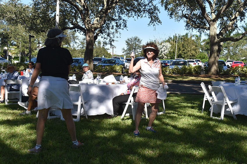 Carol Meese runs Jackie Tilton's award for 