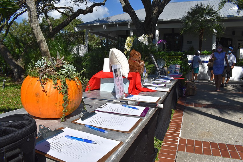 A silent auction table was available for players to bid on items including a pumpkin filled with succulents.