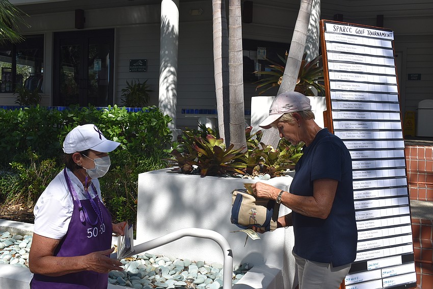 Bonnie Van Overbeke accepts 50/50 money from Lynne Koy.