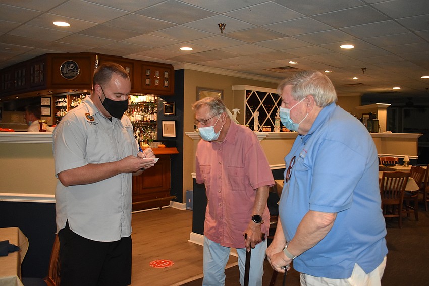 Chris Kopp shares his card with Ed Krepela and John Wild.