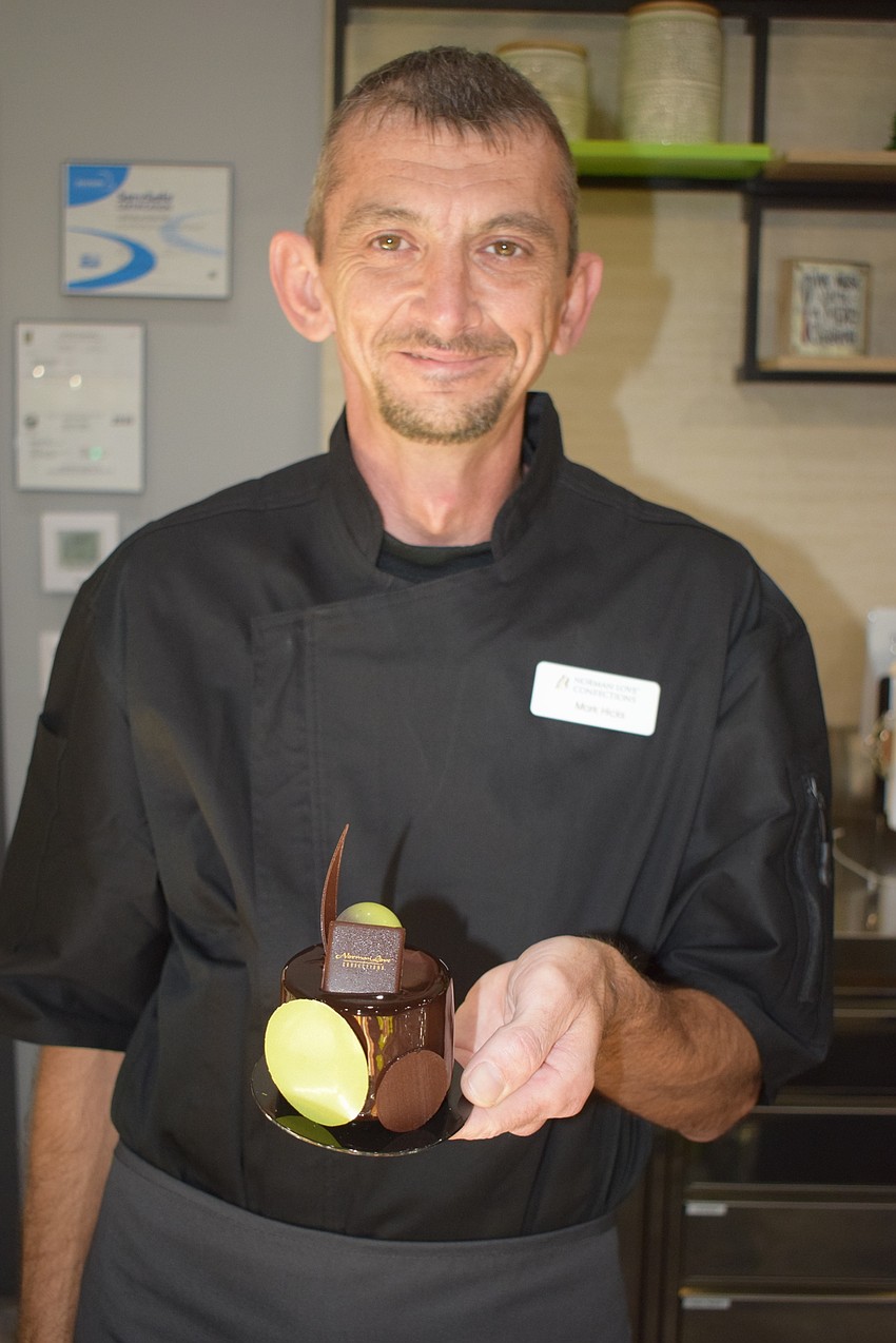 Mark Hicks, the keyholder (supervisor), at Norman Love Confections, shows off a dessert.