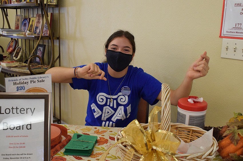 Savanna's Demitria Guimond dances to the music while manning the lottery board table.