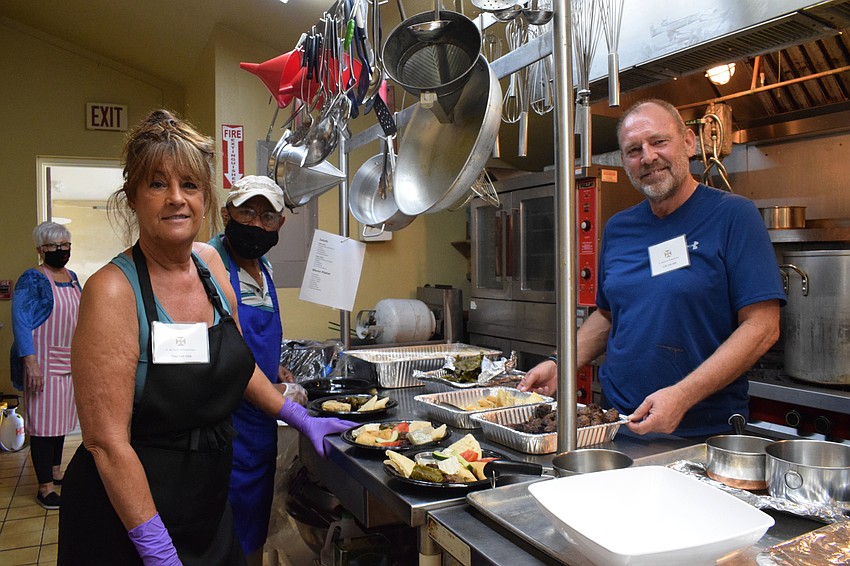 Polo Run's Atheena Van Dijk works with Palm Aire's Louis Elias and her husband, Erik Van Dijk, in the kitchen. They arrived at the church at 7 a.m. to start working on the food for the festival.