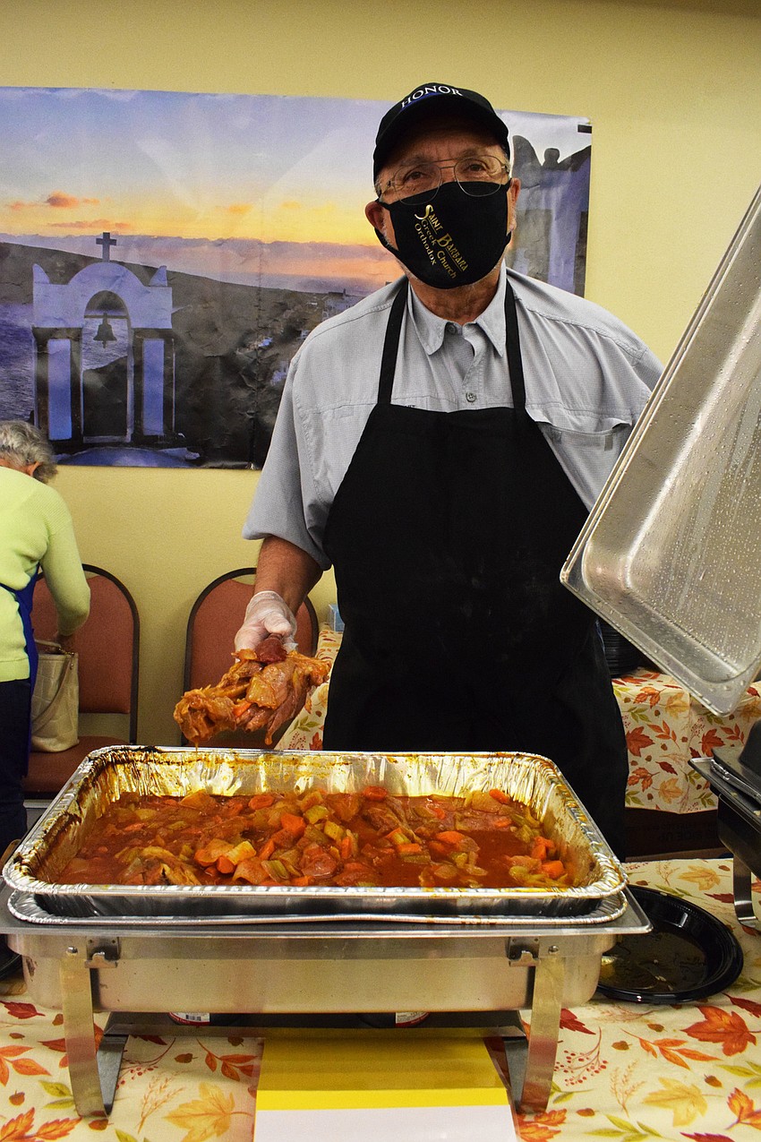 Steve Kostos serves oven roasted lamb shanks with rice, green beans and pita.