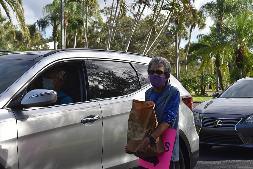 Max Spitzer carries a bag of groceries.