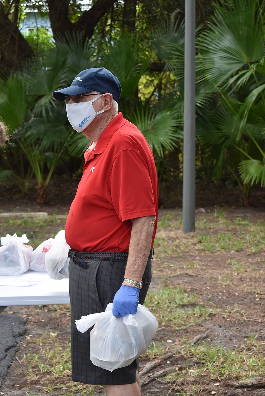 Lewis Moyer grabs apportioned dinners.