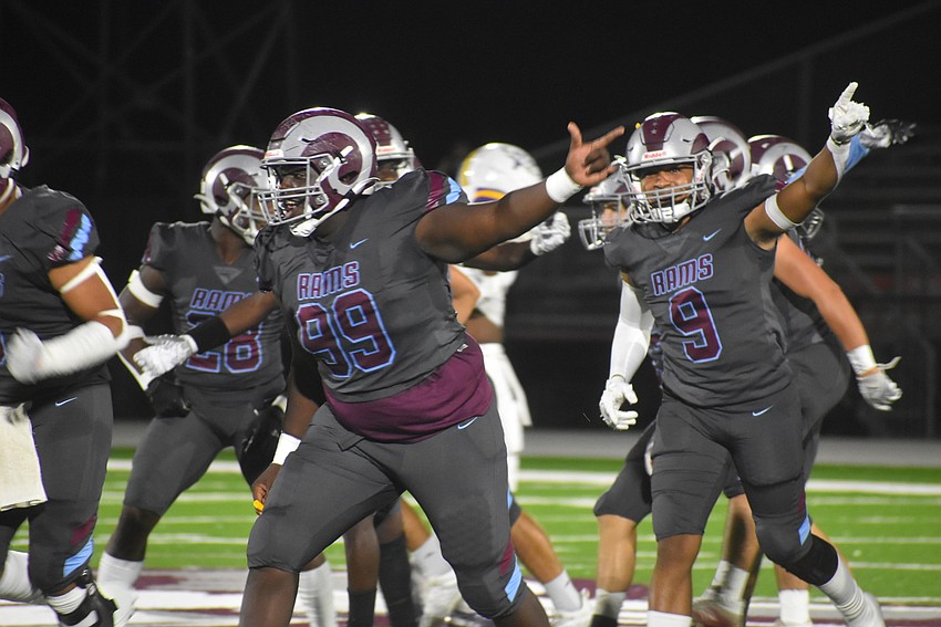 Riverview seniors Jairus Brewer (99) and Daevon Lebron (9) celebrate what they believed was an onside recovery on the game's opening kickoff. Referees eventually ruled Lennard, the receiving team, recovered the kick.