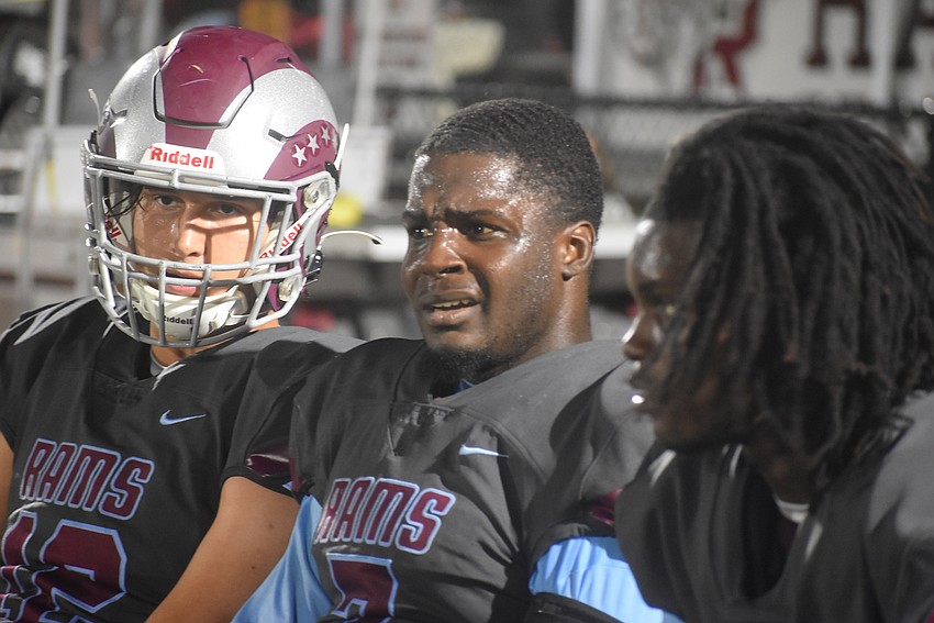 (From left) Riverview quarterback Will Evans, running back Michael 