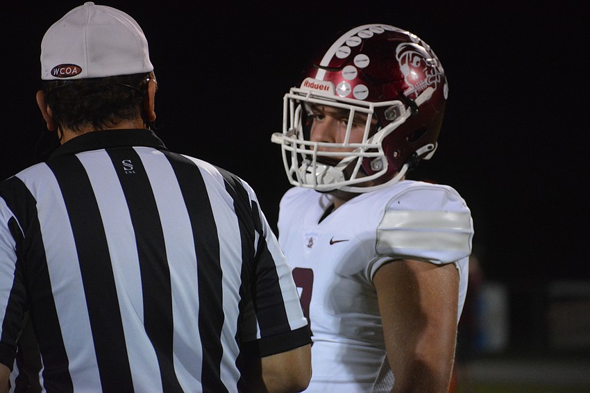Senior linebacker Shane Moran conducts the coin toss for Braden River.