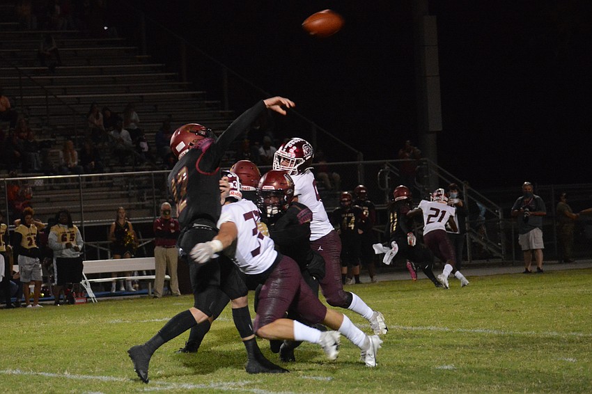 Aiden Dangler puts a hit on Lake Gibson QB Logan Hackett.