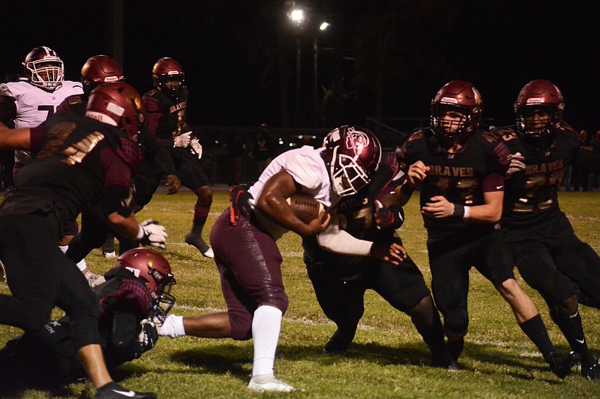 Pirates running back Jaheim Hodo bursts through the Lake Gibson defense.