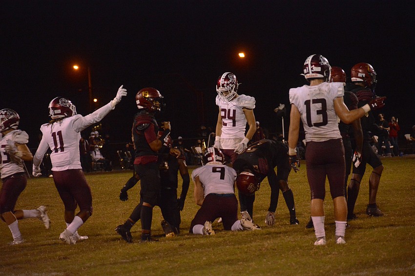 The Pirates celebrate after Shane Moran (9) recovered an onside kick late in the game.