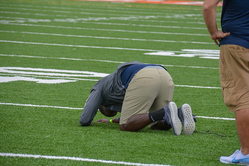 ODA Coach K.B. Belton falls to the ground after the officiating crews waives off a roughing the kicker penalty on the final play of the game.