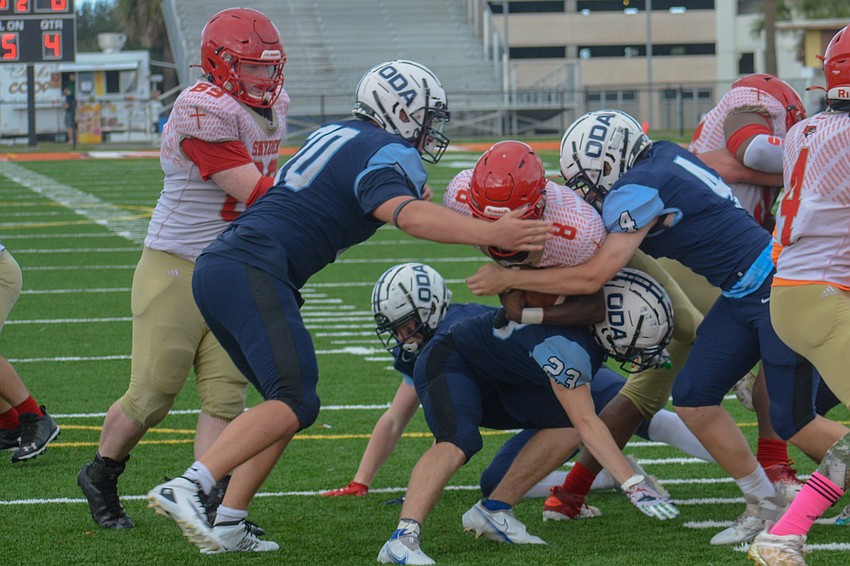 Michael Dyer (70) and Charlie Tack (4) stop a Bishop Snyder run at the goal line.
