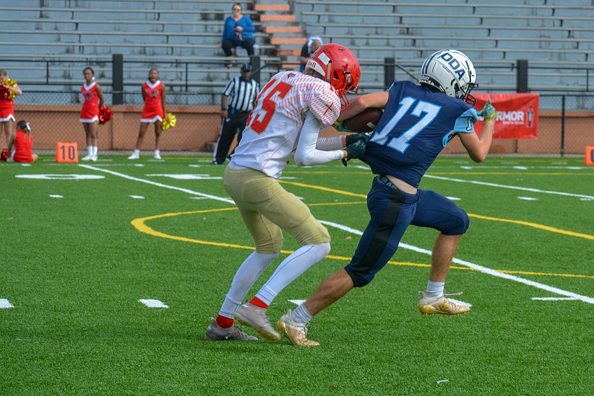 Connor Pope surges toward the end zone as Bishop Snyder's James Bishop pulls his jersey.