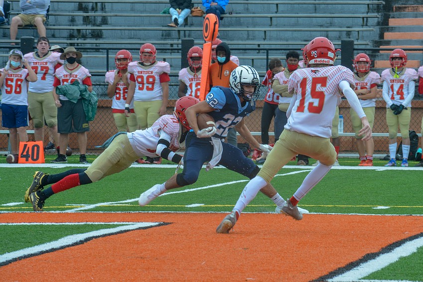 Nolan Lewellen (22) jukes James Bishop (15) in the open field.