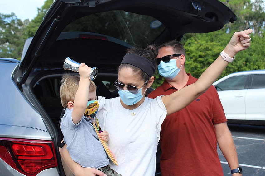Allison and Bryan Albright showed their son Dylan how to raise his Yiddish cup in a toast.