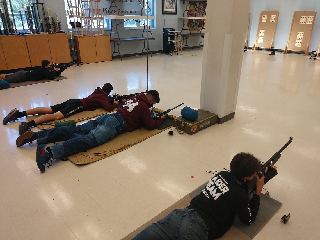 Braden River High School sophomore Christian Bell, freshman Nathan Walmsley and seniors Alex Bustillo and Phil Staffiles  practice for their rifle competition. Courtesy photo.