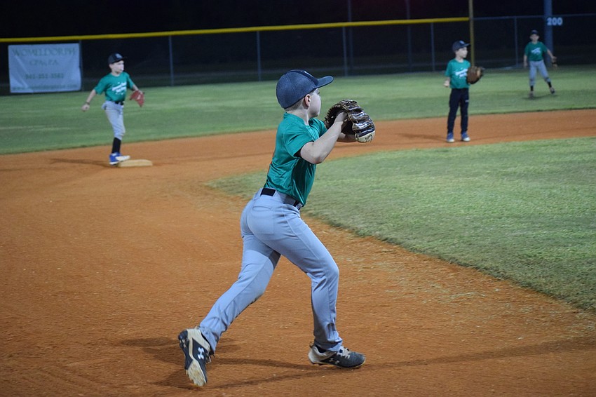 Landon Biggs gets ready to make a throw to first base.