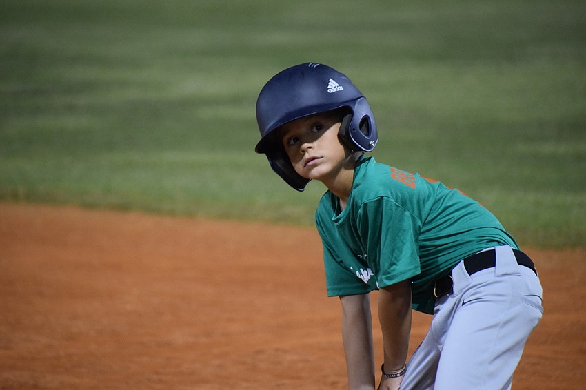 David Brierton listens to instructions from a coach after reaching base.