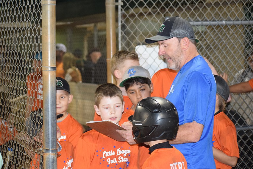 Coach Jim Chalmers goes over his lineup with Austin Alonso, Brayden Gagnon and Paul Deery.