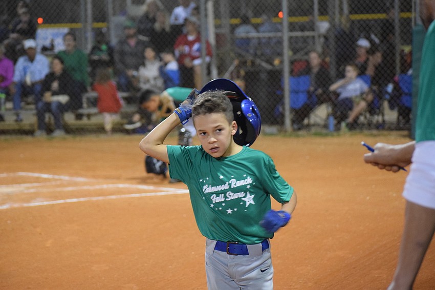 Grayson Desmond returns to the dugout after scoring a run.