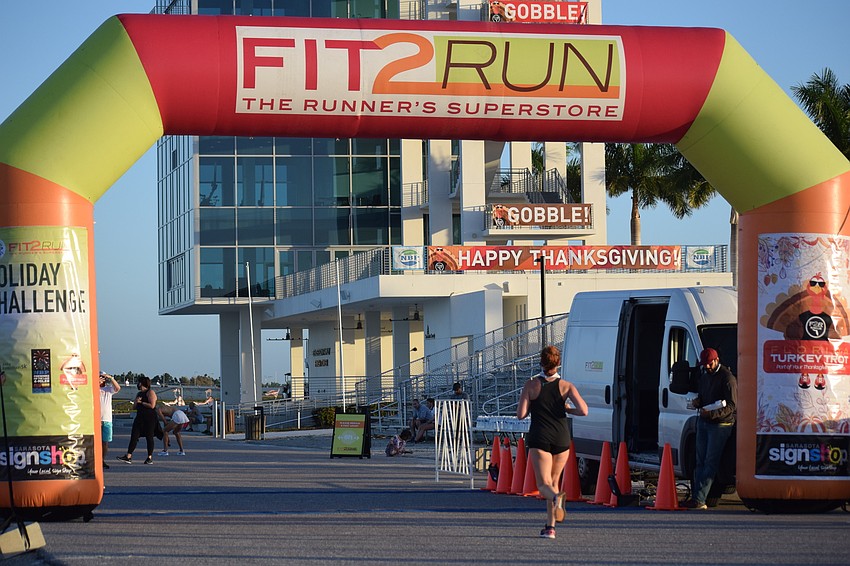 Runners finished with a festival finish tower in the background.