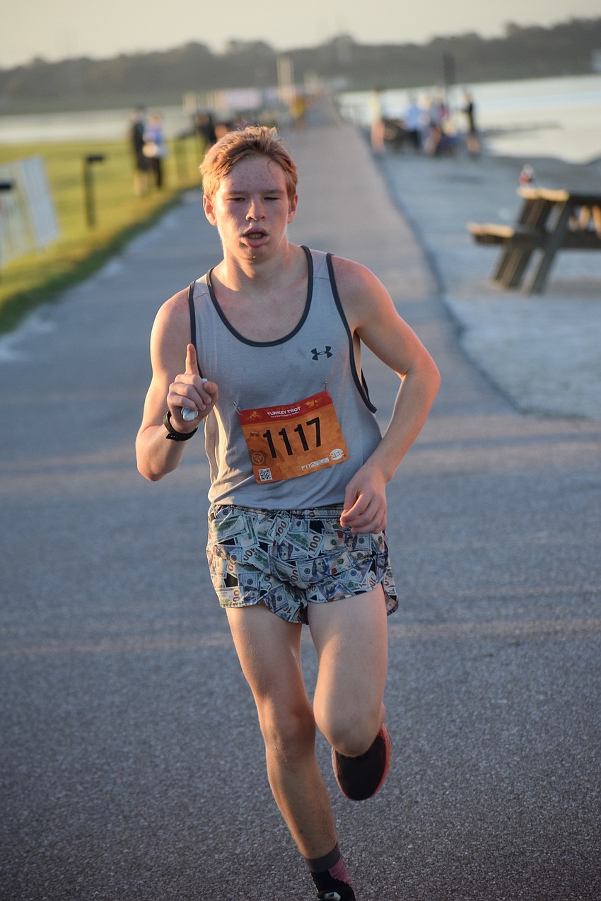Griffin McNeish of Summerville, S.C., lets people know he finishes No. 1 among the first wave of runners.