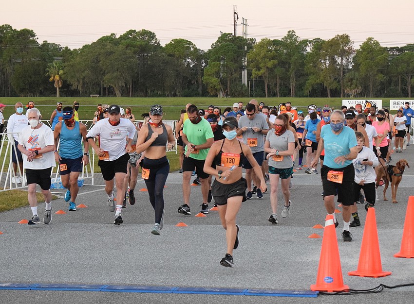 Runners sprint away at the start of the first group.