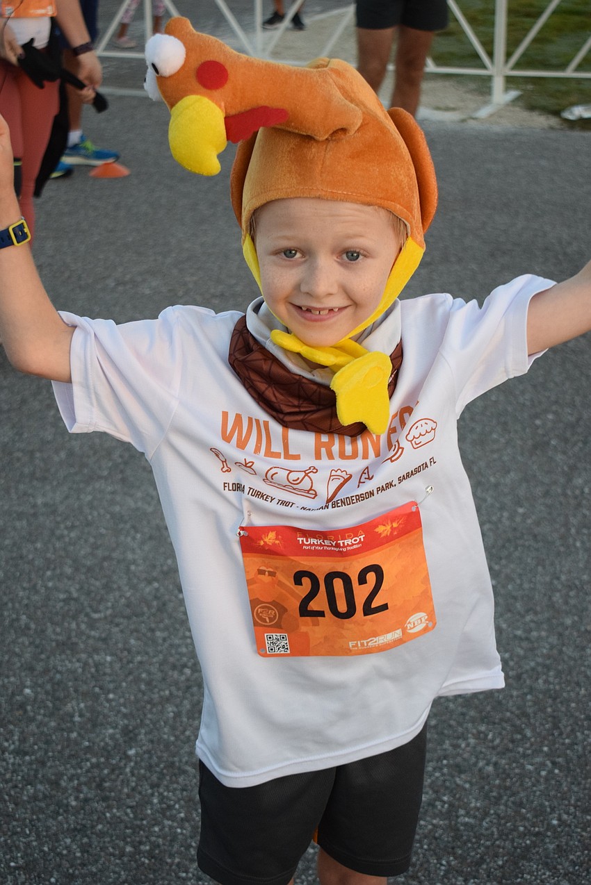 Parrish 9-year-old Evan Fulton is excited to get the race started. He ran with dad Ian and mom Valerie.