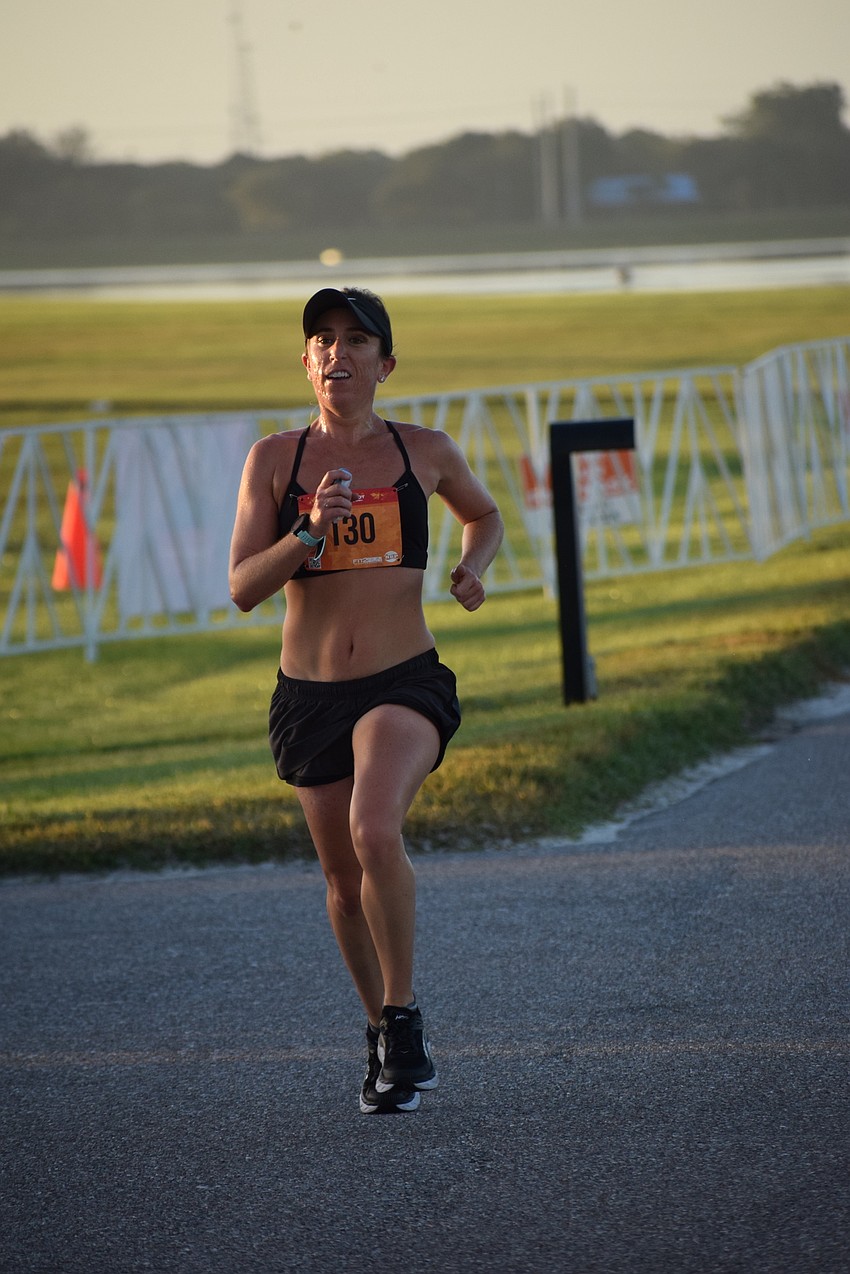 Sarasota's Lauren Lumley finishes first among the women in the first wave of runners. She was thrilled because it was her first race since the pandemic began.