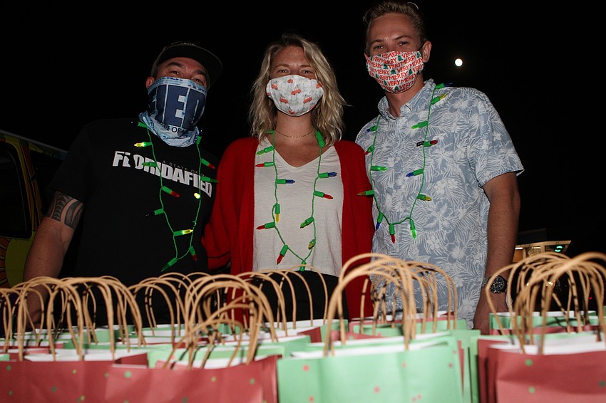 Wendall Jacobsen, Kate Balas and Kurt Krenz handed out gift bags.