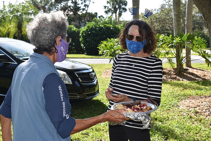 Mac Spitzer offers a brownie to Karen Gary