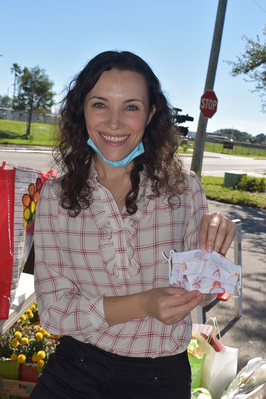 Svetlana Kaminsky shows a child-sized mask made by one of the Lakewood Ranch women's groups.