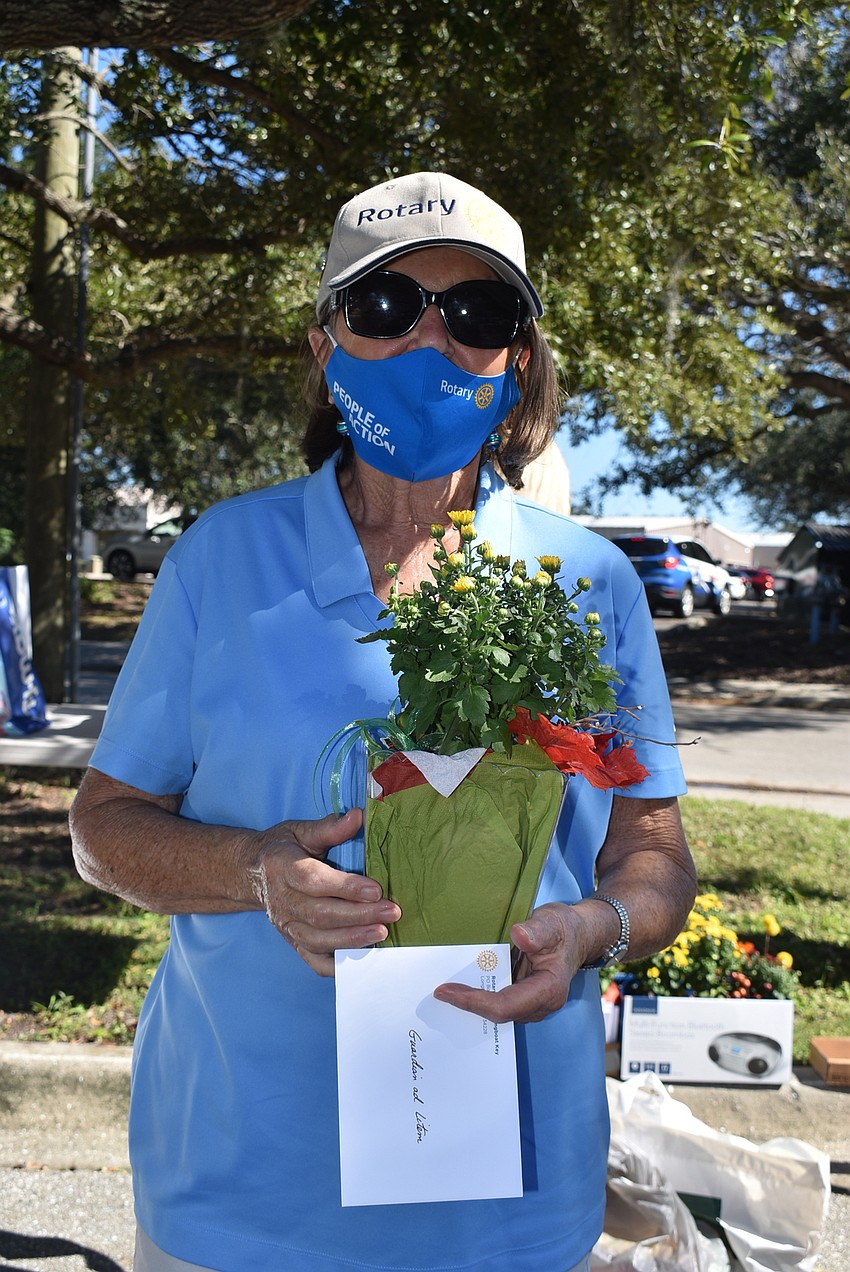 Brigitte Burdick holds a flower that will be given to the guardians ad litem.