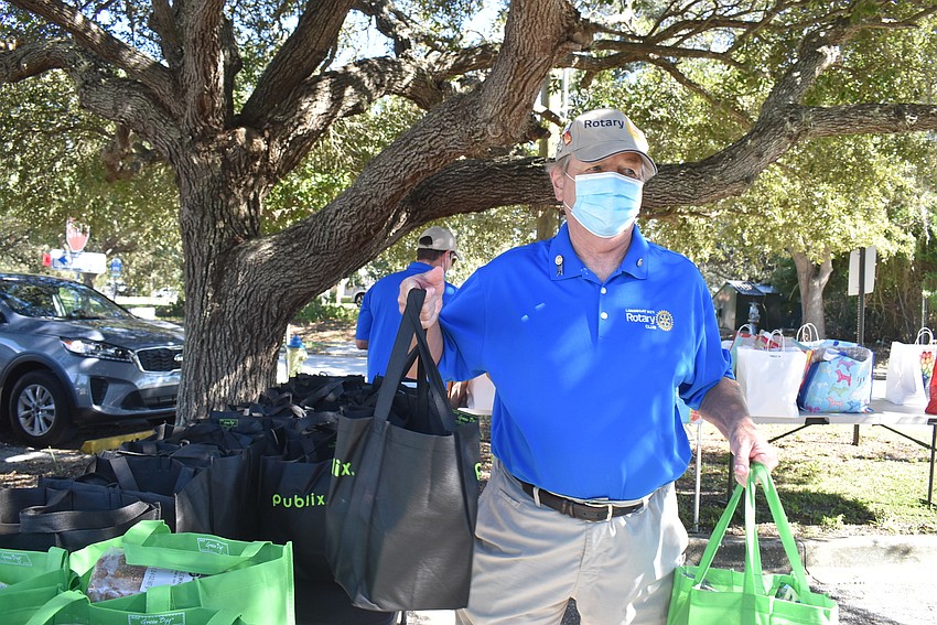 Jack Rozance carries bags to a guardian's car.