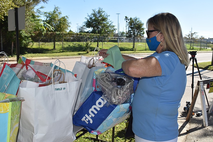 Susan McGuire rearranges the bags as the guardians picked them up.