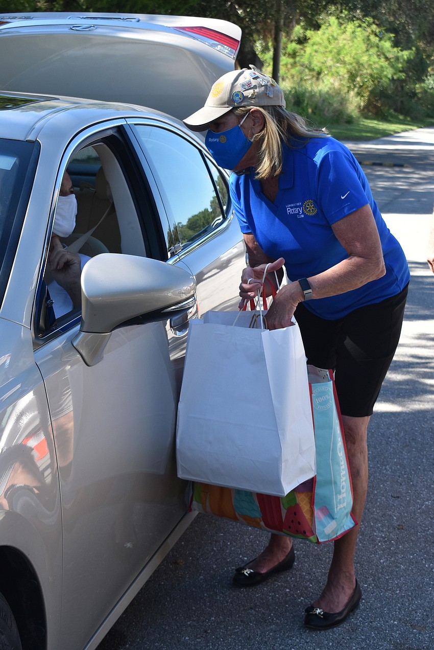 Nancy Rozance hands a bag to a guardian.