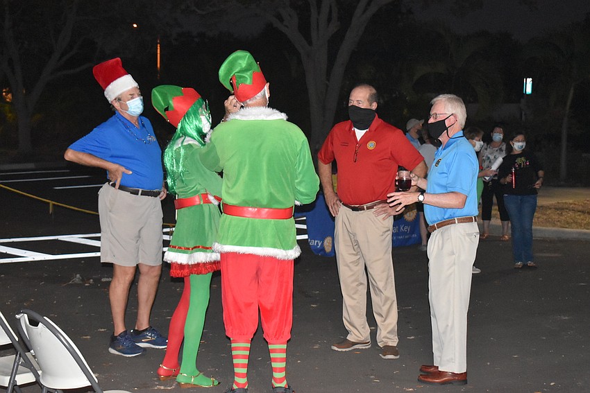 Town manager Tom Harmer and Mayor Ken Schneier (right) speak to a pair of their more festive constituents.
