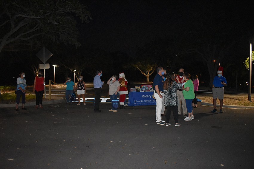 Attendees spread out in the old Amore Restaurant parking lot.