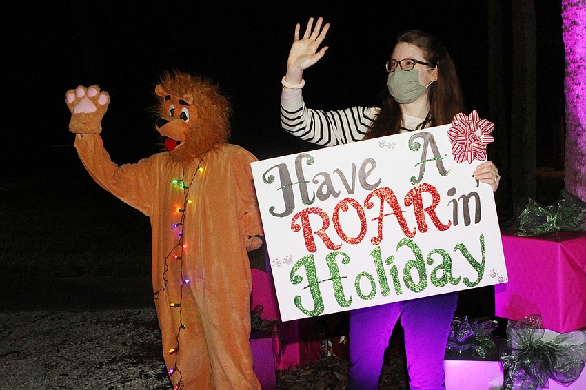 Ruben the Lion and Laura Steefel-Moore waved thanks to families.